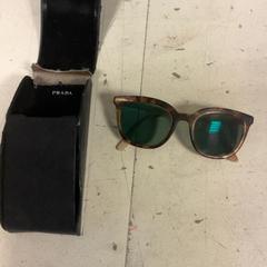 Sunglasses Prada, as reported by Artis using iLost