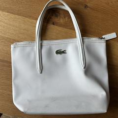 Handtas Lacoste wit, ha sido reportado a iLost