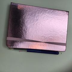 Pink metallic notebook with pen, as reported by Rijksmuseum using iLost
