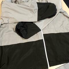 Kleding - Regenjas grijs/zwart, ha sido reportado por Centraal magazijn con iLost