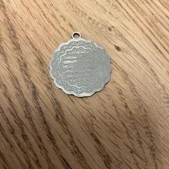 Pendant Metal Pedant Quran verse, as reported by MEININGER Hotel Amsterdam Amstel using iLost